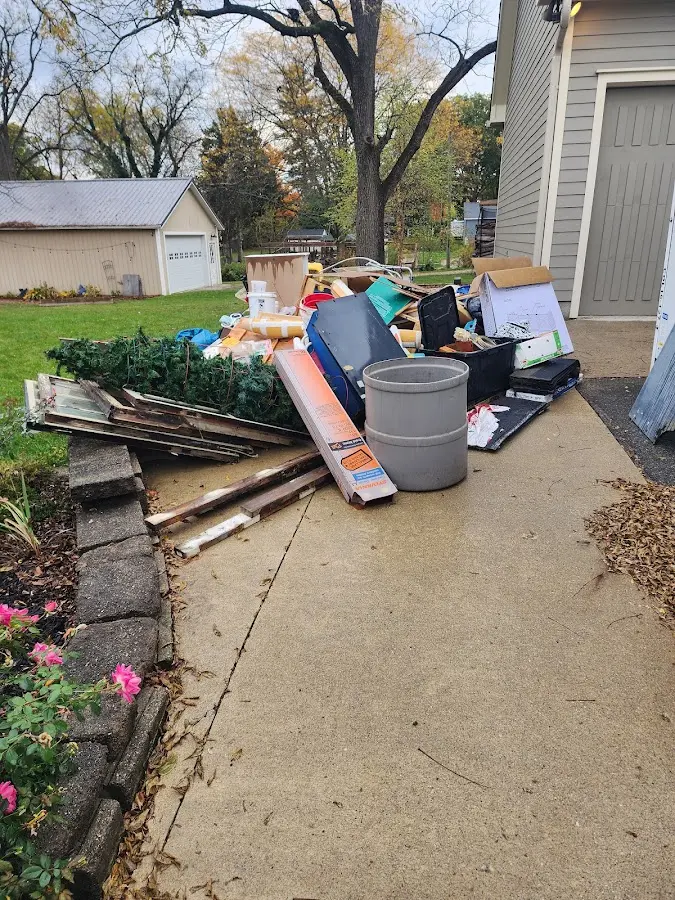 Dumpster being loaded with debris for Estate Cleanout Dumpster Rental in Junction City